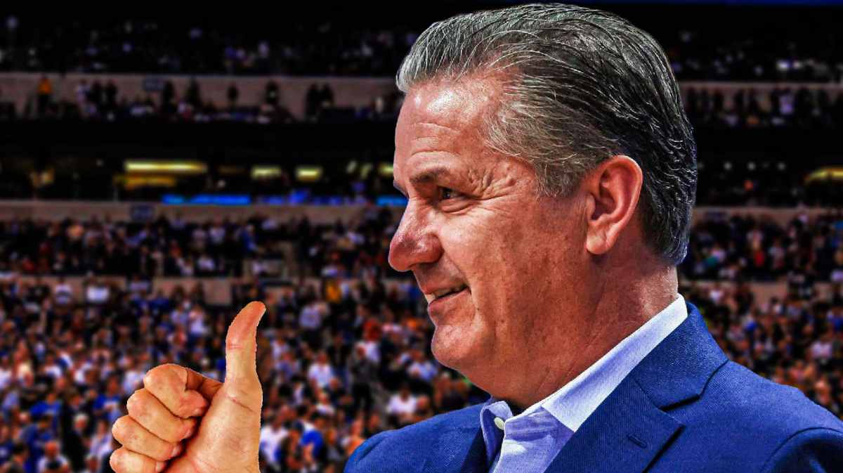 Kentucky coach John Calipari in the foreground, with a thumbs up sign.