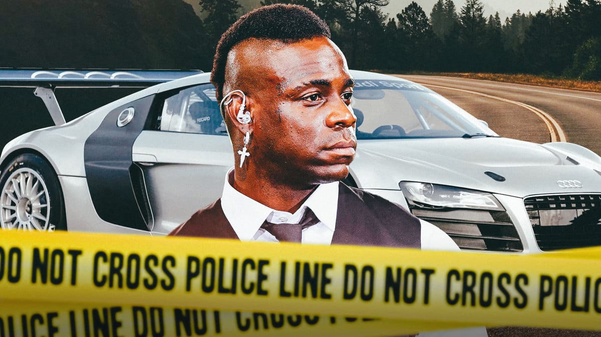 Mario Balotelli with Police lines in front of him, an Audi R8 car behind him