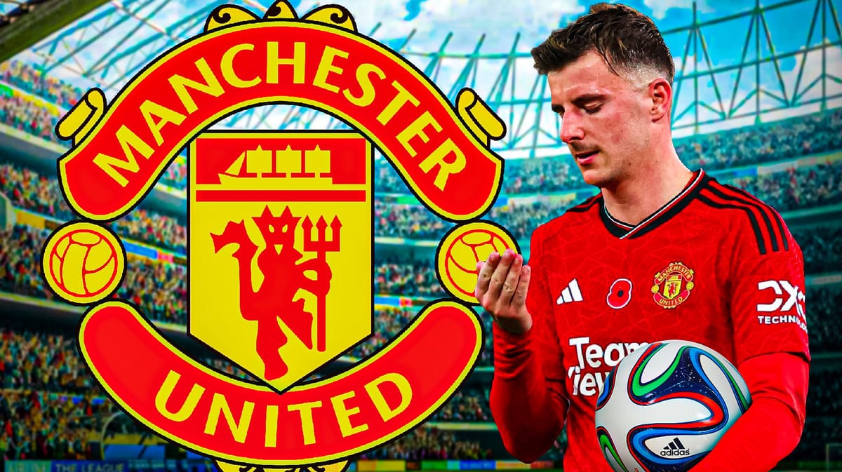 Mason Mount looking down/sad in front of the Manchester United logo