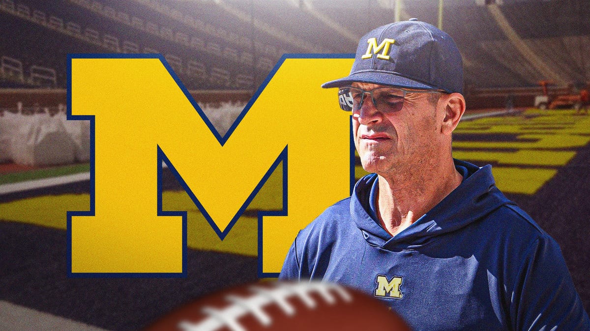 Jim Harbaugh looking disappointed with the Michigan logo in the background