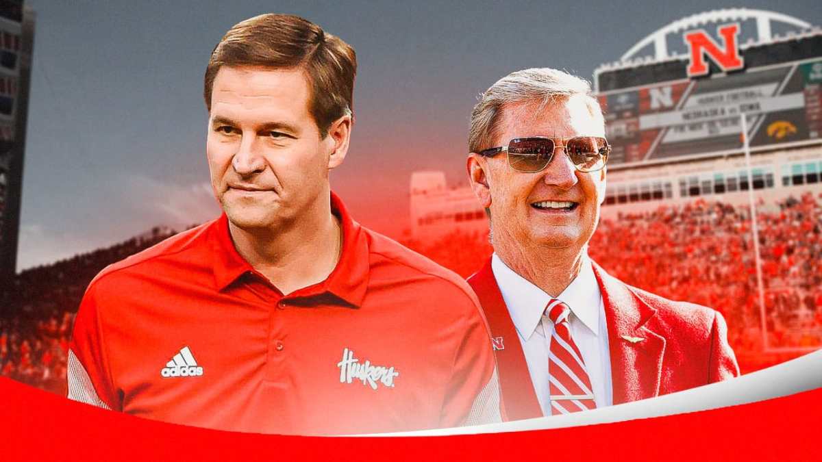 Photo: Trev Alberts in Nebraska gear with Nebraska president Ted Carter in a suit, both smiling