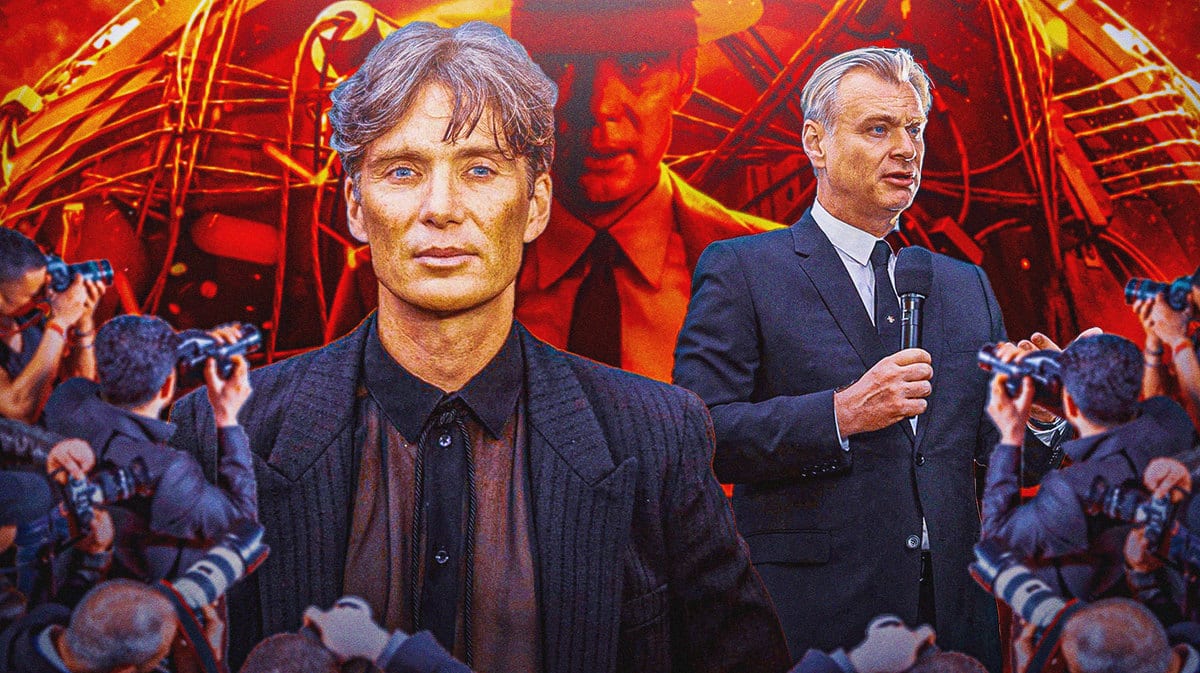 Cillian Murphy and Christopher Nolan in front of Oppenheimer poster.
