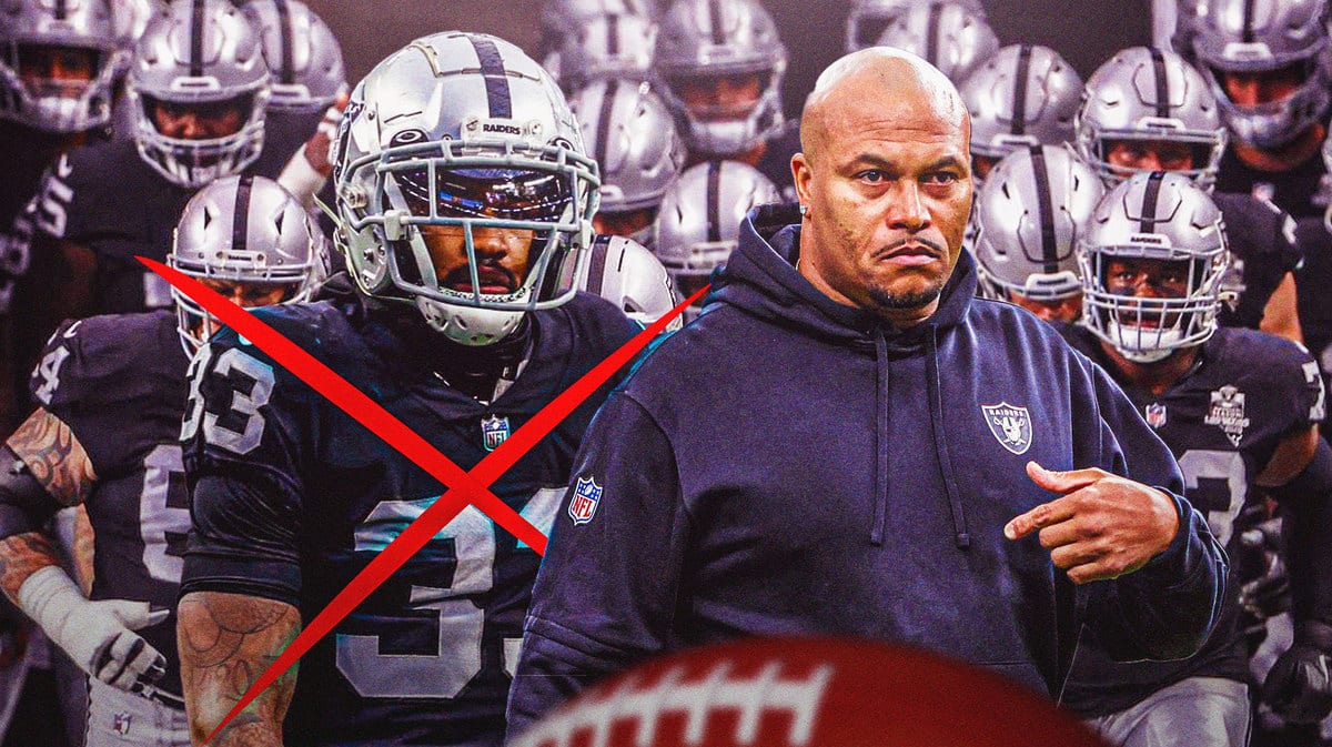 Photo: Antonio Pierce coaching Raiders looking serious, Roderic Teamer looking serious beside him in Raiders jersey with an X through him