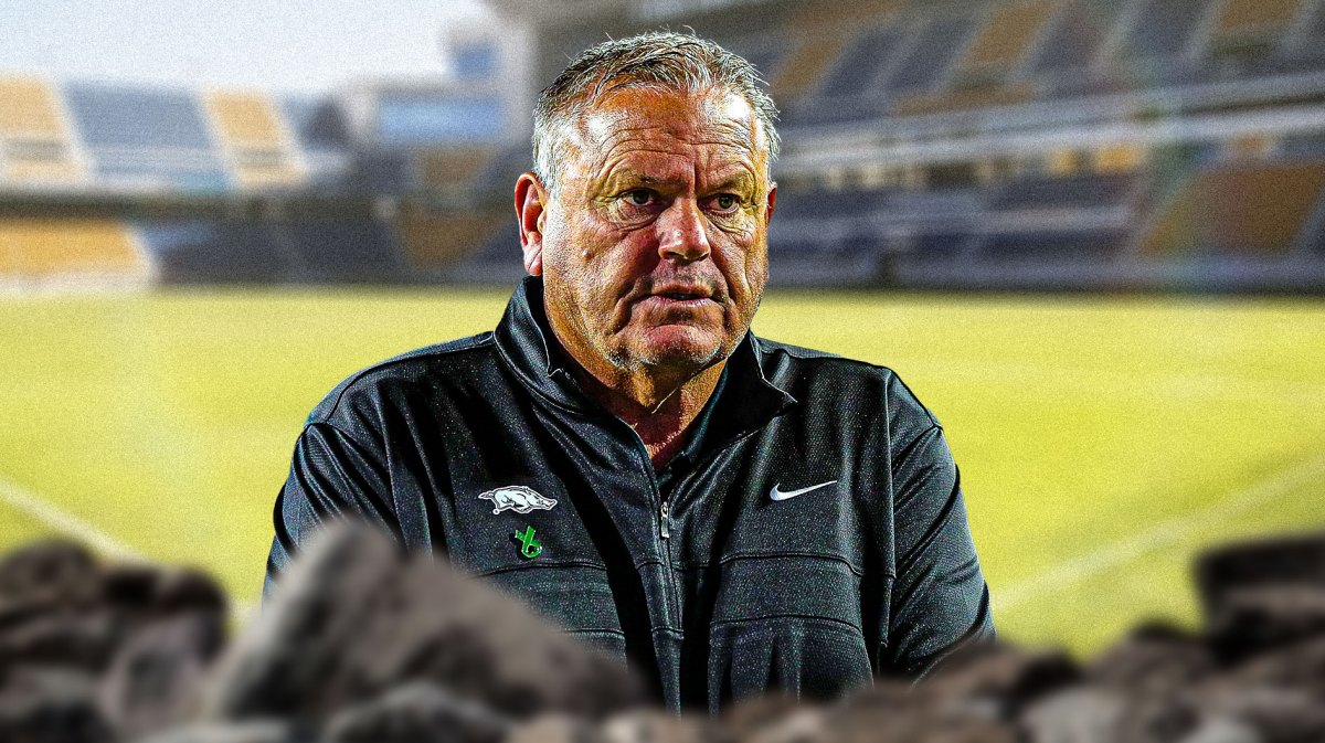 Arkansas coach Sam Pittman looking stern, in the foreground.
