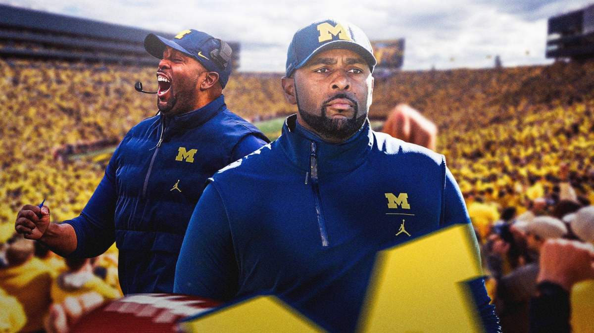 Michigan football coach Sherrone Moore in the foreground, looking excited.