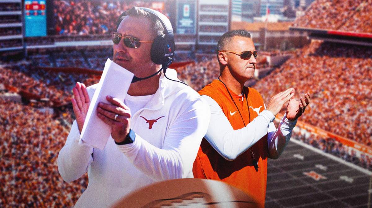 Texas football coach Steve Sarkisian in the foreground, on the left and right, clapping. Texas fans in the background.