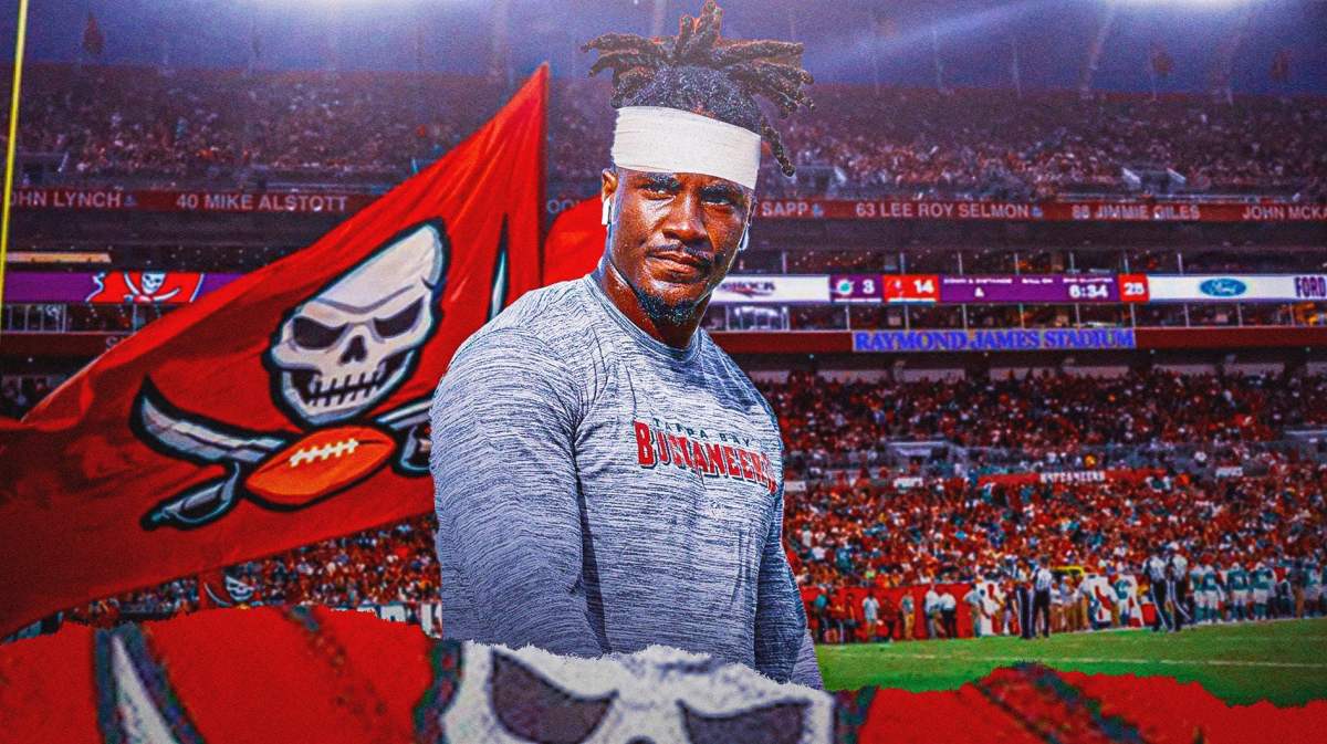 Tampa Bay Buccaneers running back Rachaad White in the foreground with a bandage on head.