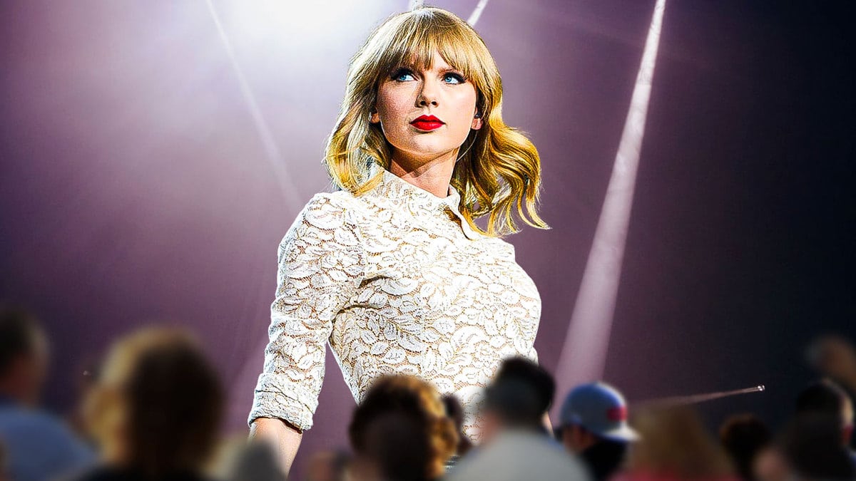 Taylor Swift on stage and a crowd beneath her.