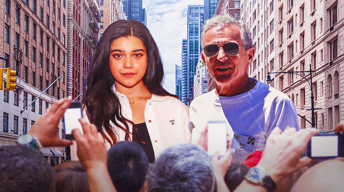 Iman Vellani with Bob Igor and buildings in the background with fans upfront.