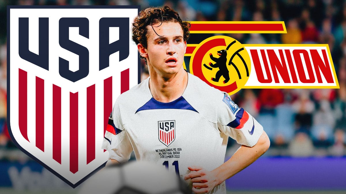 Brenden Aaronson in front of the USMNT and Union Berlin logos
