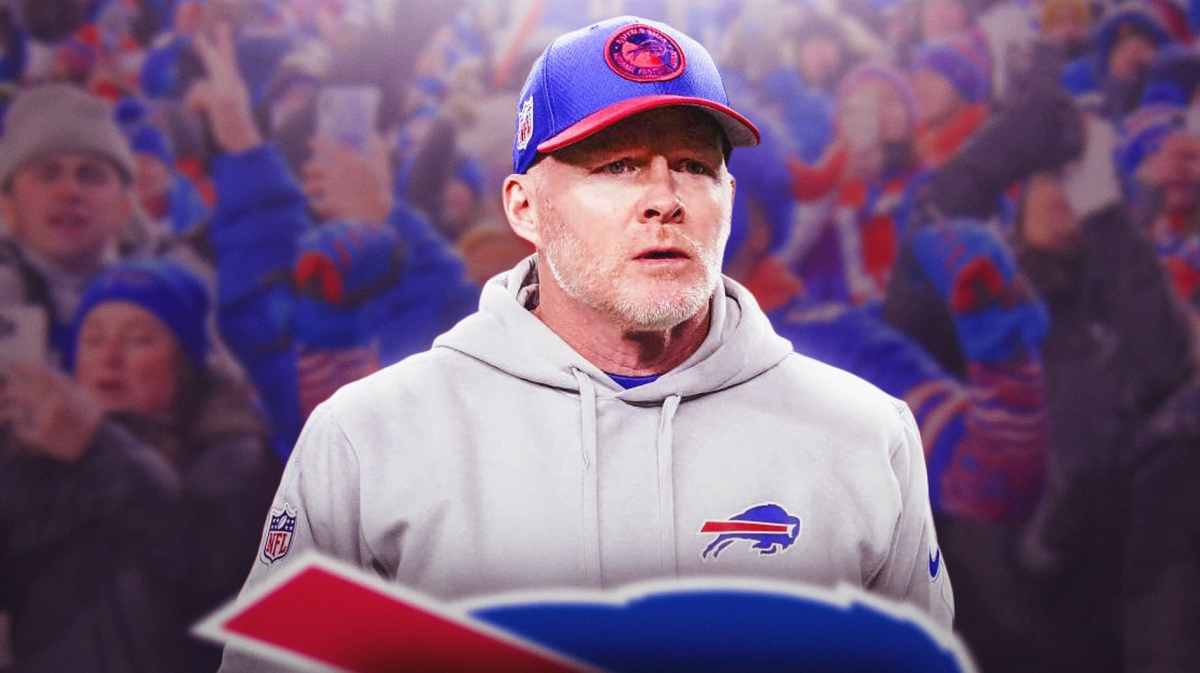 Buffalo Bills coach Sean McDermott looking somber in the foreground, fans yelling in the background.