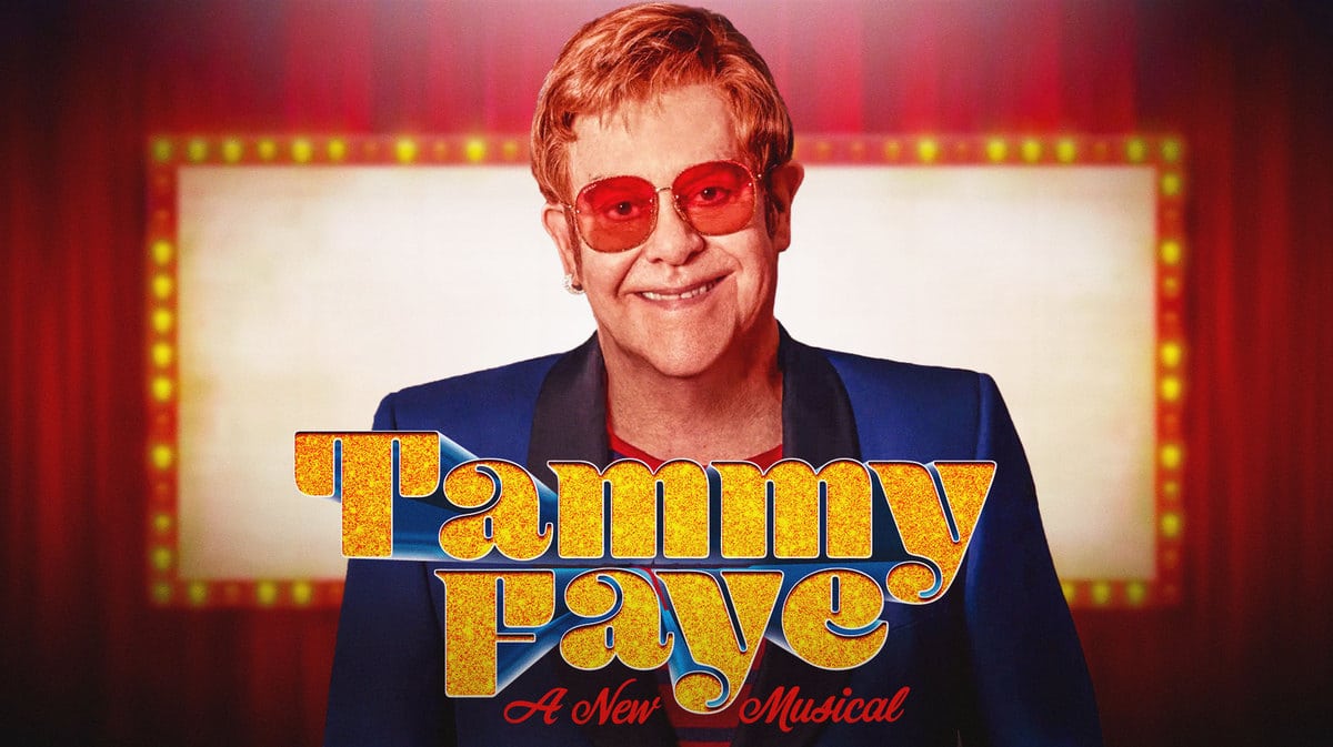 Elton John with a Tammy Faye the Musical sign in front.