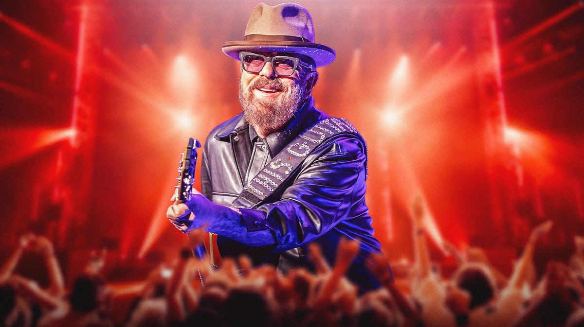 Dave Stewart on stage with fans in front.