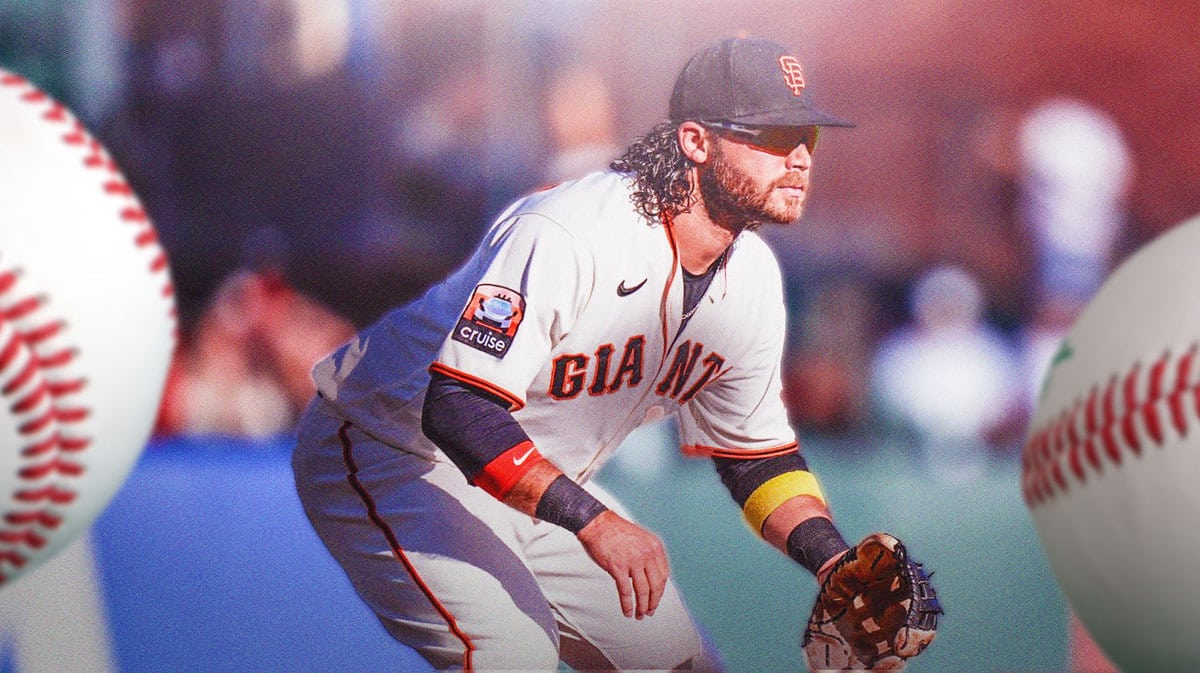 Giants' Brandon Crawford with a baseball glove on, catching a baseball