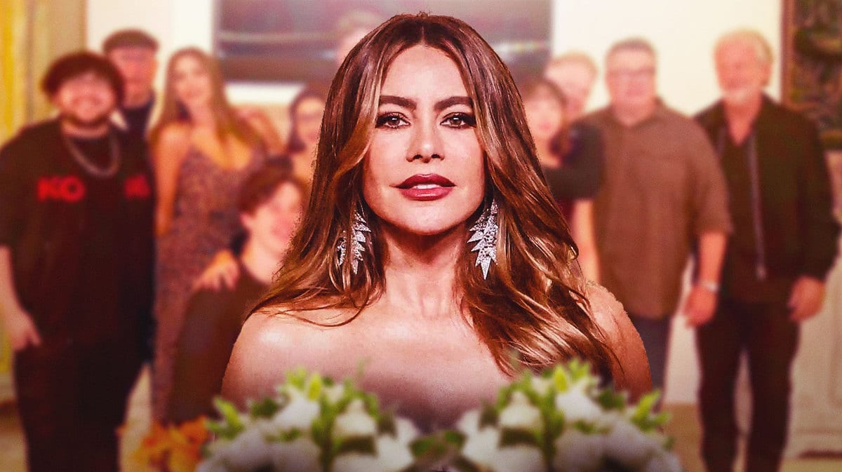 Sofia Vergara and the cast of Modern Family in the background.