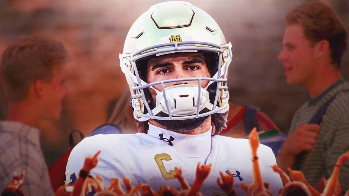 Notre Dame quarterback Sam Hartman looks frustrated as players laugh behind him.
