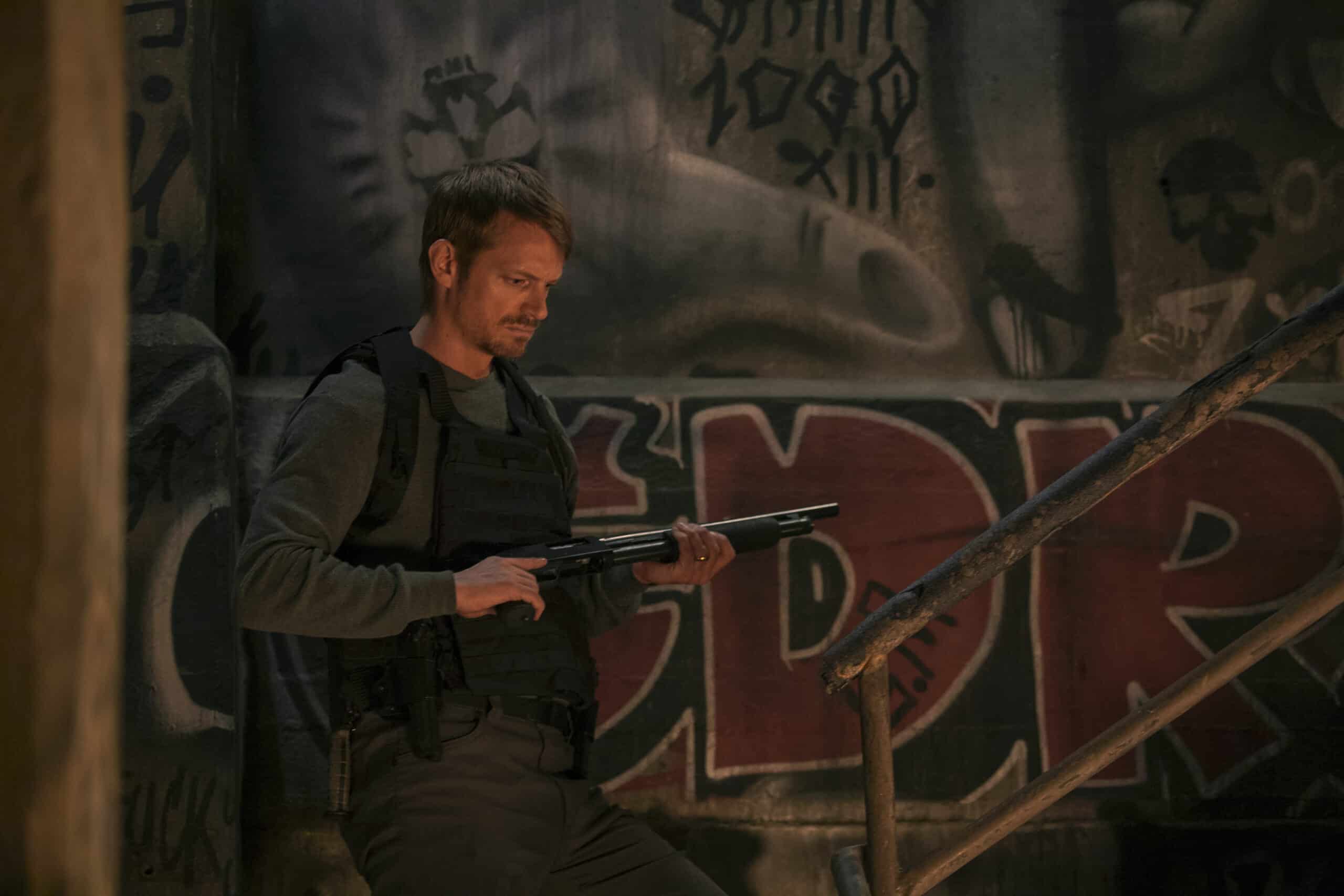 Joel Kinnaman with a gun.