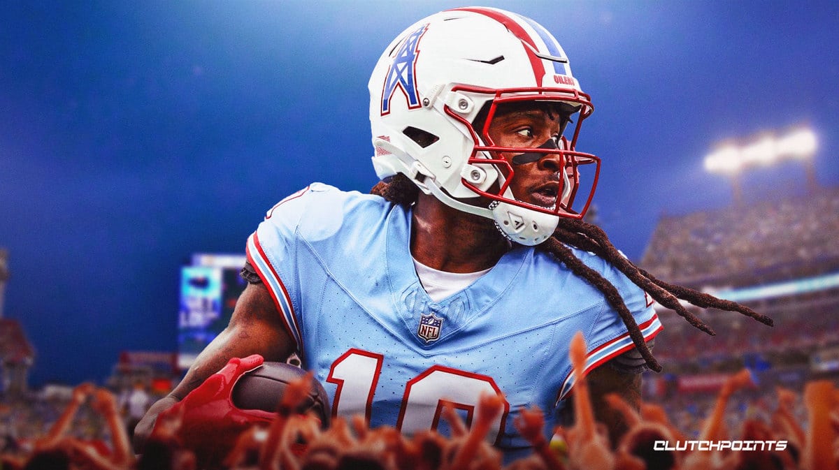 DeAndre Hopkins in a Titans jersey with a football in his hands