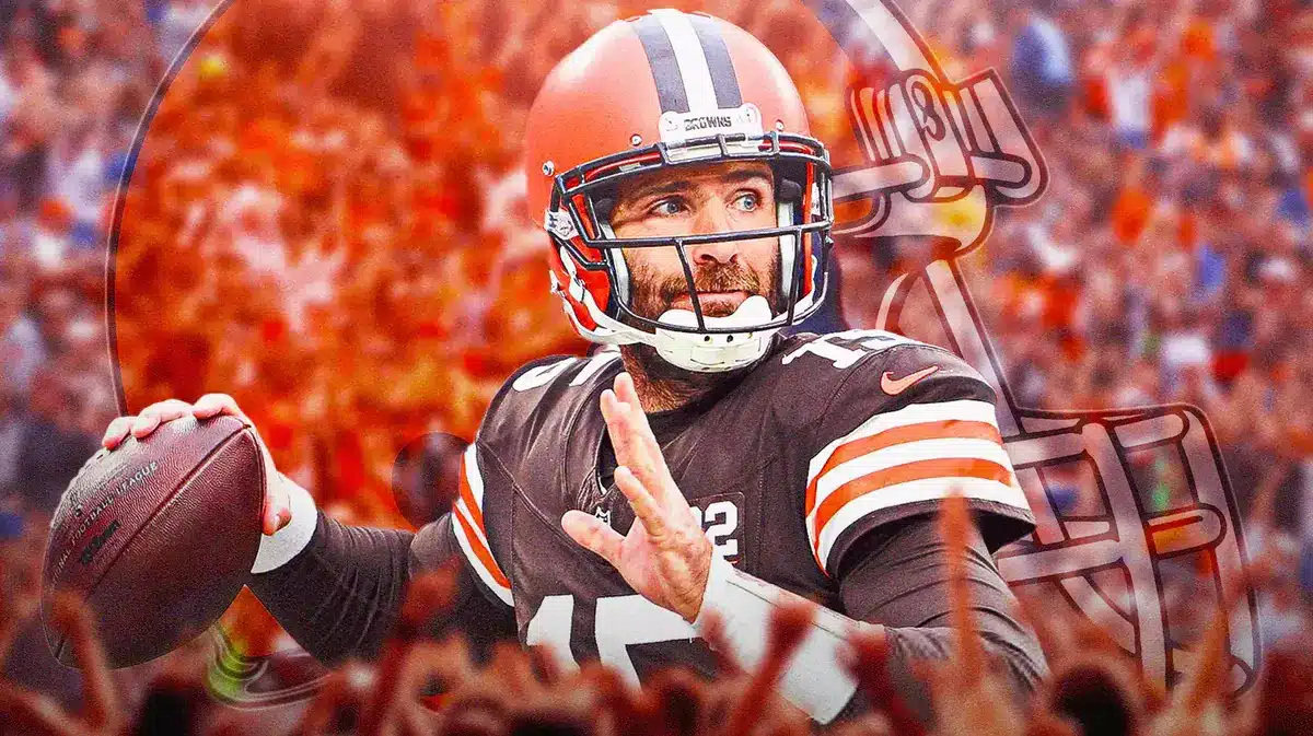 Photo: Joe Flacco in Browns gear smiling with Browns logo and fans behind him