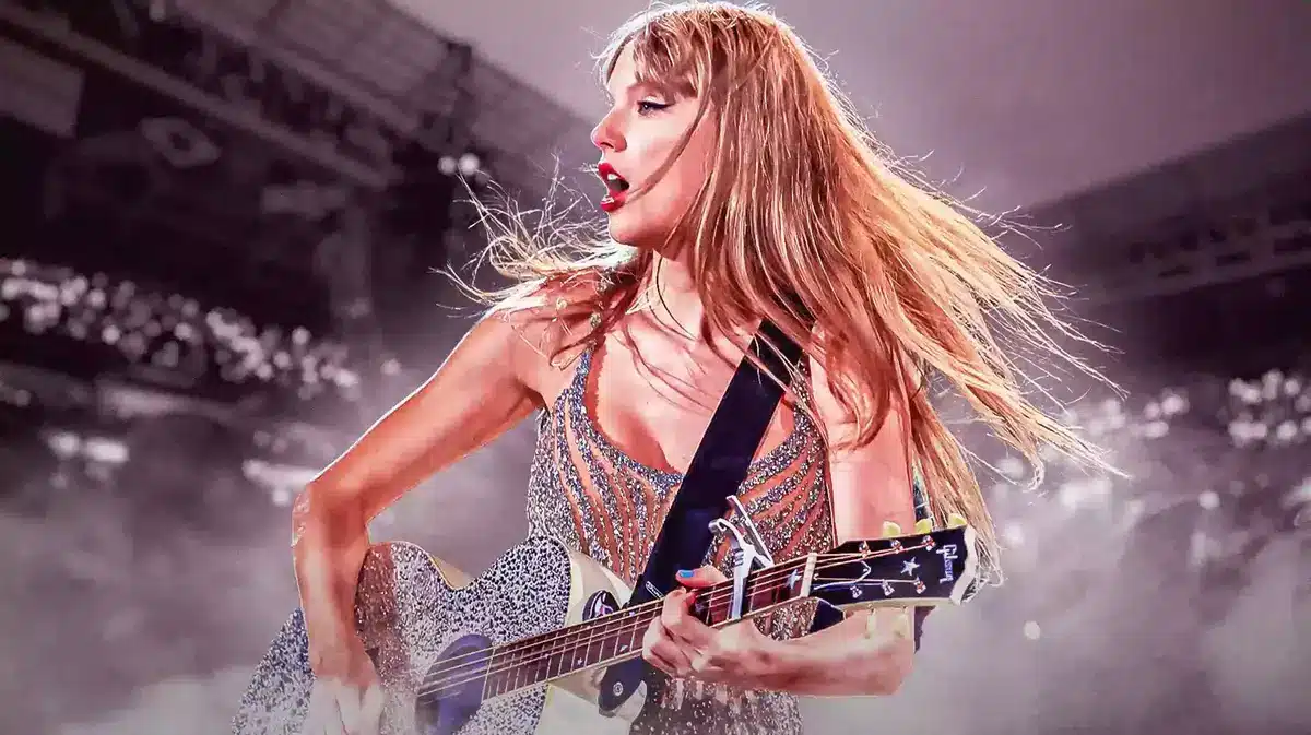 Taylor Swift on stage holding her guitar