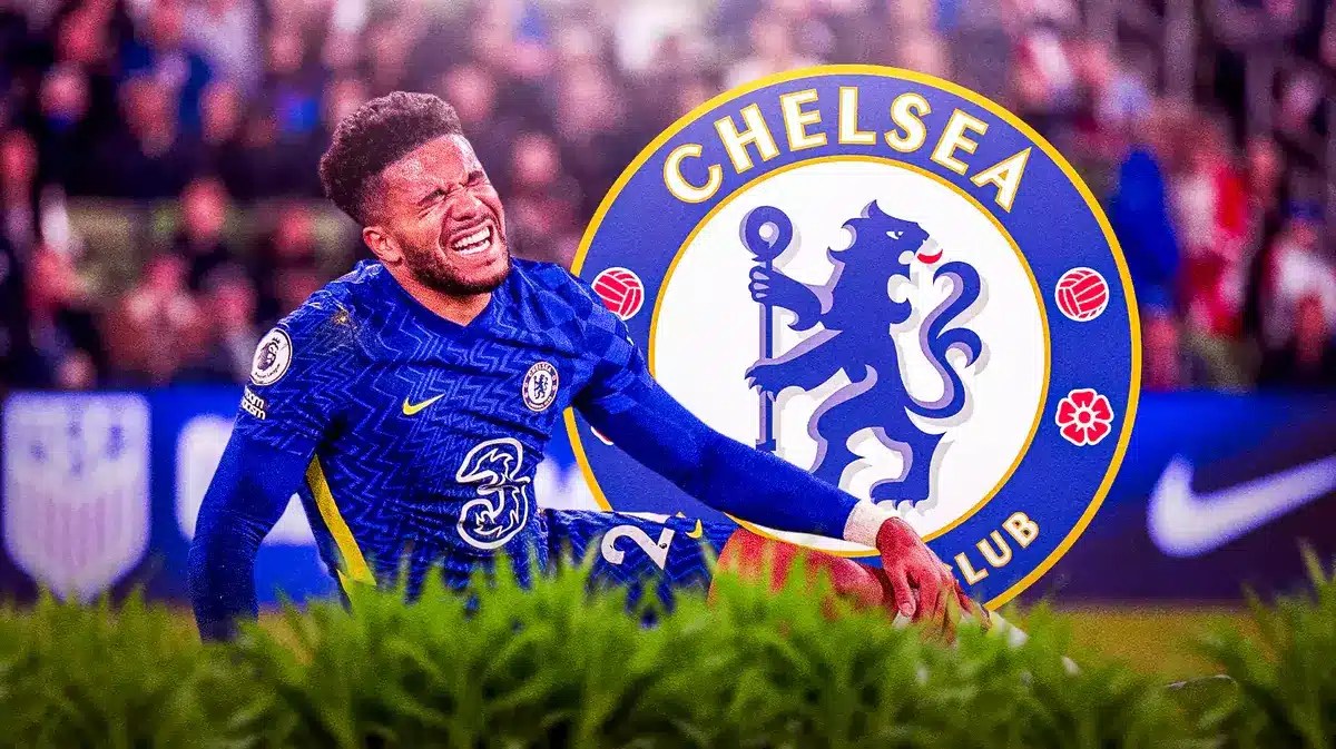 Reece James injured in front of the Chelsea logo