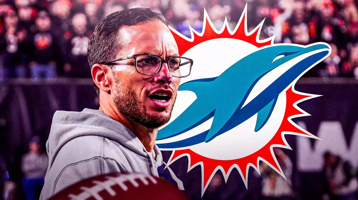 Dolphins coach Mike McDaniel looking angry. Dolphins logo on the right.