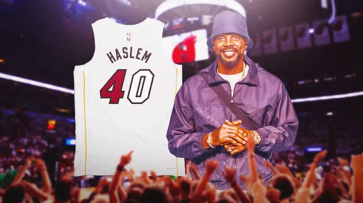 Former Miami Heat player Udonis Haslem next to his jersey in front of the Kaseya Center.