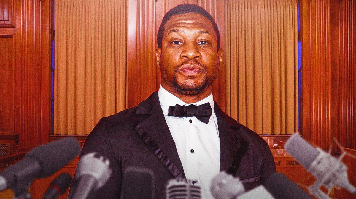 Actor Jonathan Majors with microphones in front of him.
