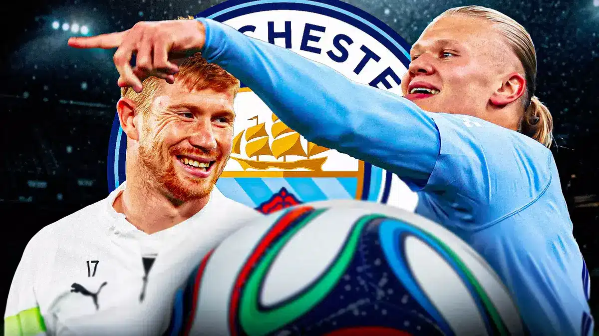 Kevin De Bruyne and Erling Haaland happy together in front of the Manchester City logo