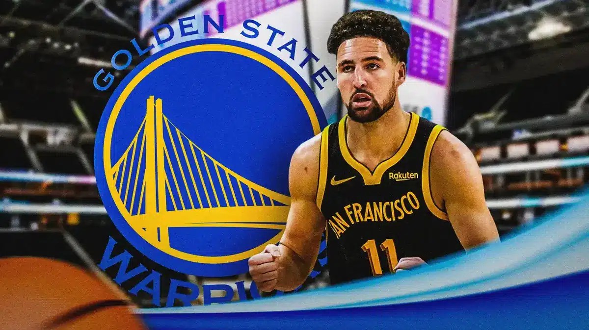 Photo: Klay Thompson with Warriors logo behind him