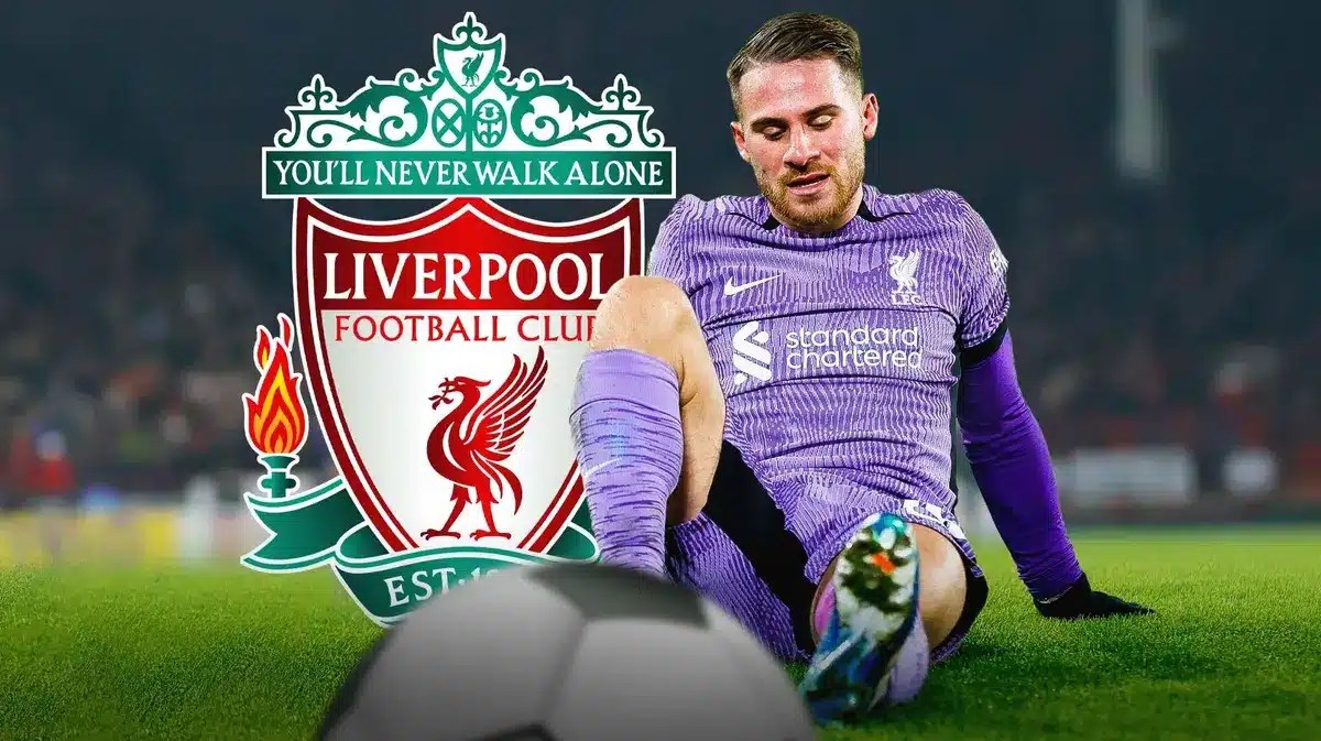 Alexis Mac Allister injured in front of the Liverpool logo