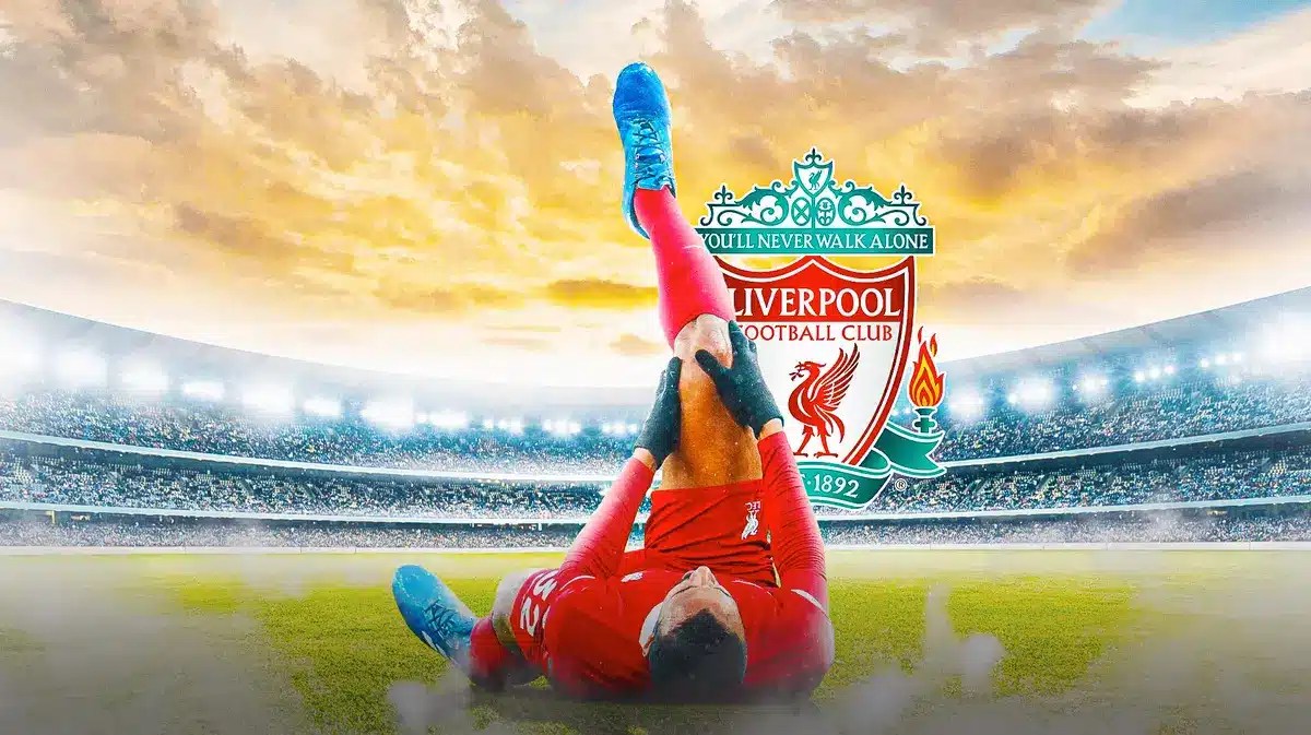 Joel Matip injured in front of the Liverpool logo