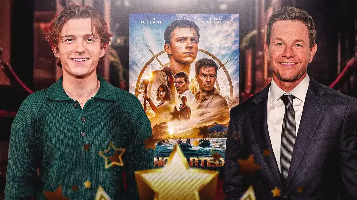 Tom Holland and Mark Wahlberg around Uncharted poster.