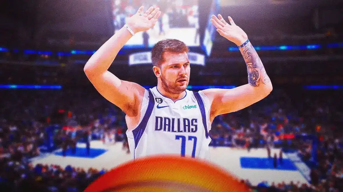 Mavs' Luka Doncic with his arms in the air looking confused at the American Airlines Center.