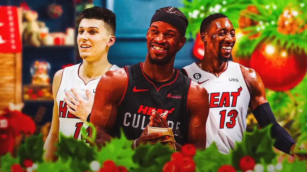 Miami Heat stars Jimmy Butler, Tyler Herro, and Bam Adebayo in front of Christmas decorations.