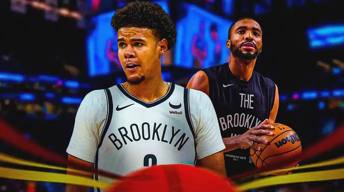 Nets' Cam Johnson in front looking serious. Nets' Mikal Bridges in background shooting a basketball.