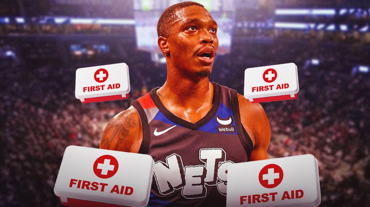 Photo: Lonnie Walker IV in Nets jersey looking serious with medical kits around him