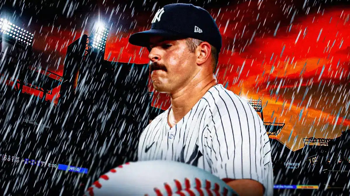 Carlos Rodon looking down. Dark background with rain falling