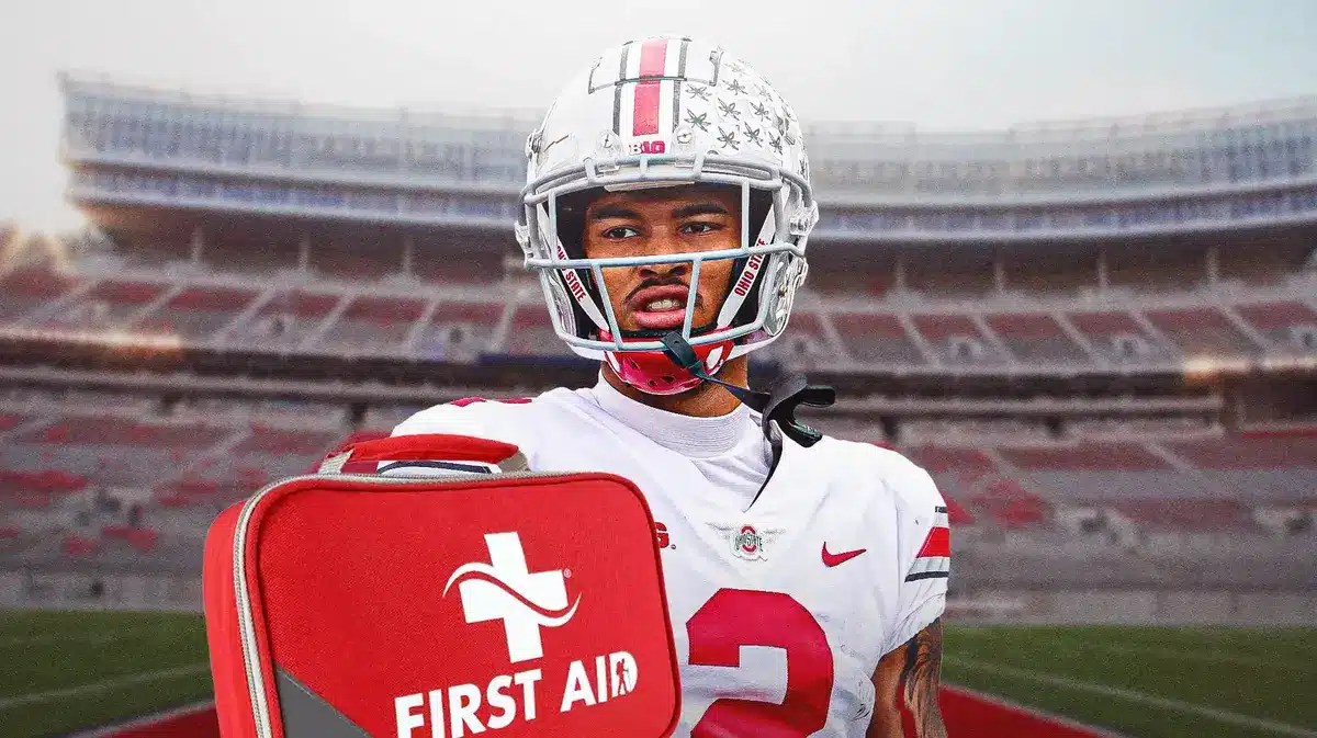 Photo: Emeka Egbuka in Ohio State football jersey with medical kit beside him