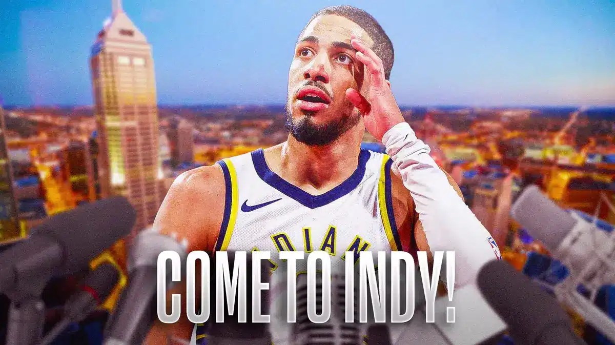 Tyrese Haliburton in the middle with a microphone in front of him with the Indianapolis skyline in the background.