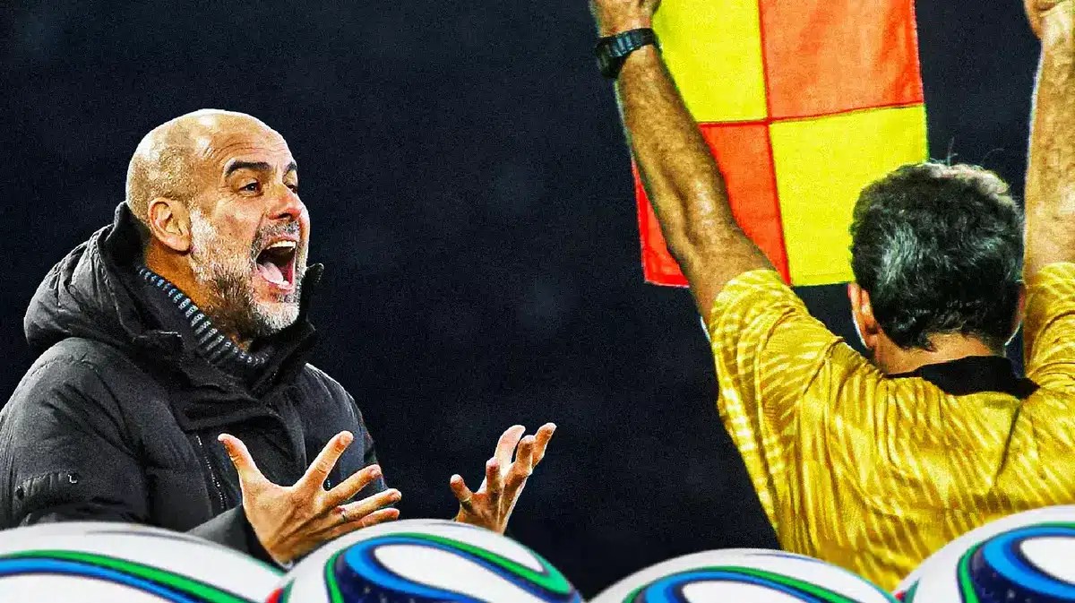 Pep Guardiola shouting at a referee in front of the Manchester City logo