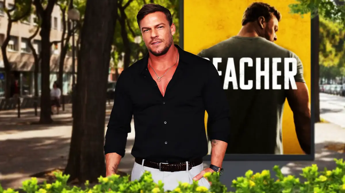 Alan Ritchson with a Reacher poster in the backgorund.