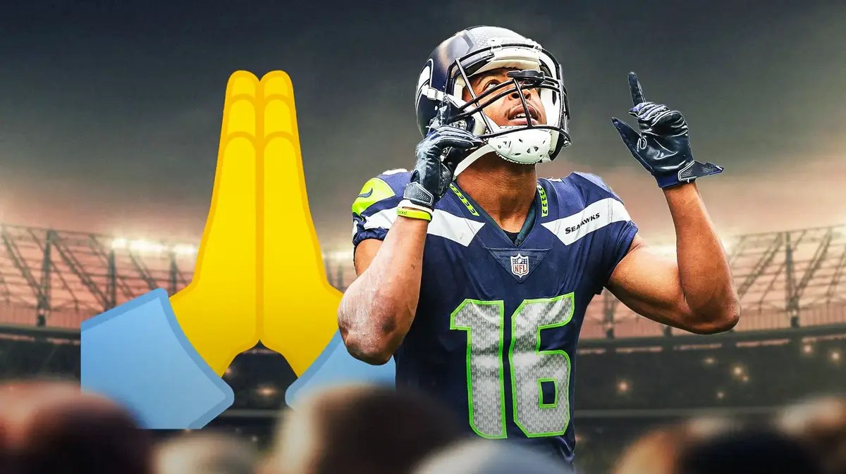 Tyler Lockett pointing up at the sky with a Prayer emoji in the background