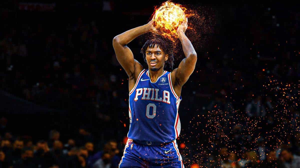 Sixers star Tyrese Maxey holding a flaming basketball