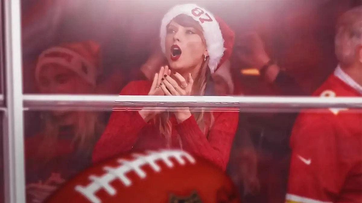 Taylor Swift watching the Chiefs game in the suite and wearing a Santa hat with Travis Kelce's number 87 on it