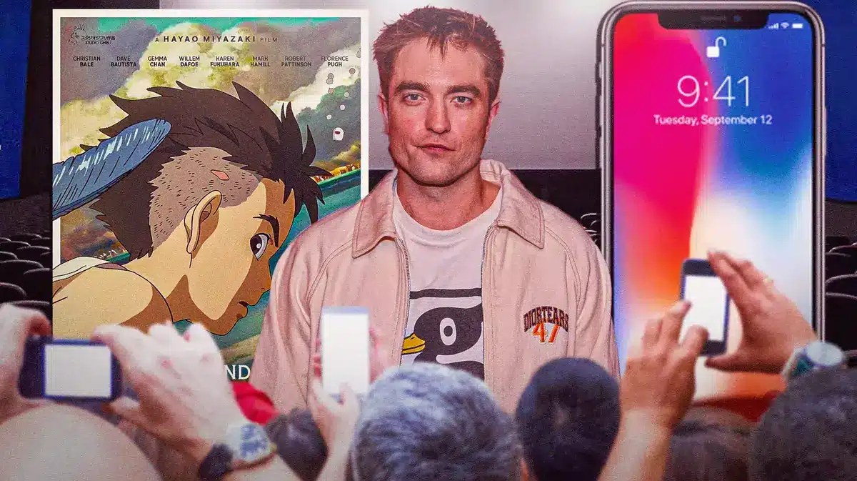 Robert Pattinson between Studio Ghibli The Boy and the Heron poster and iPhone.