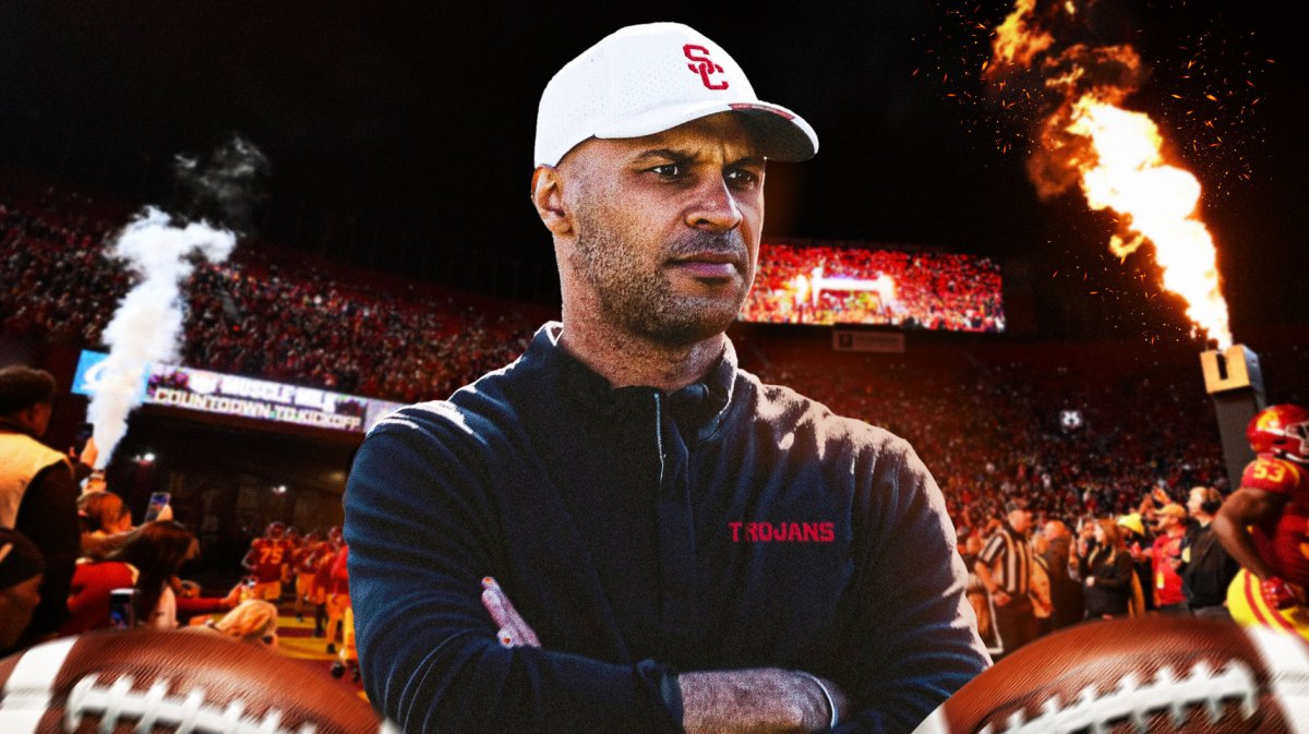USC football, Trojans, D'Anton Lynn, USC defense, USC defensive coordinator, D’Anton Lynn in USC gear with USC football stadium in the background