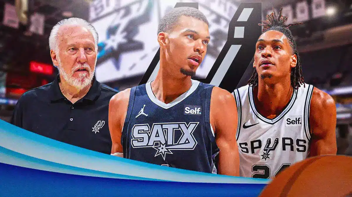 Victor Wembanyama in middle of image looking stern, Gregg Popovich and Devin Vassell on either side looking stern, SA Spurs logo, basketball court in background