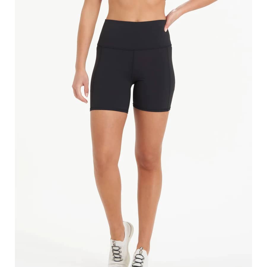 Vuori Studio Pocket Biker Shorts - Black colored on a model on a light gray background.