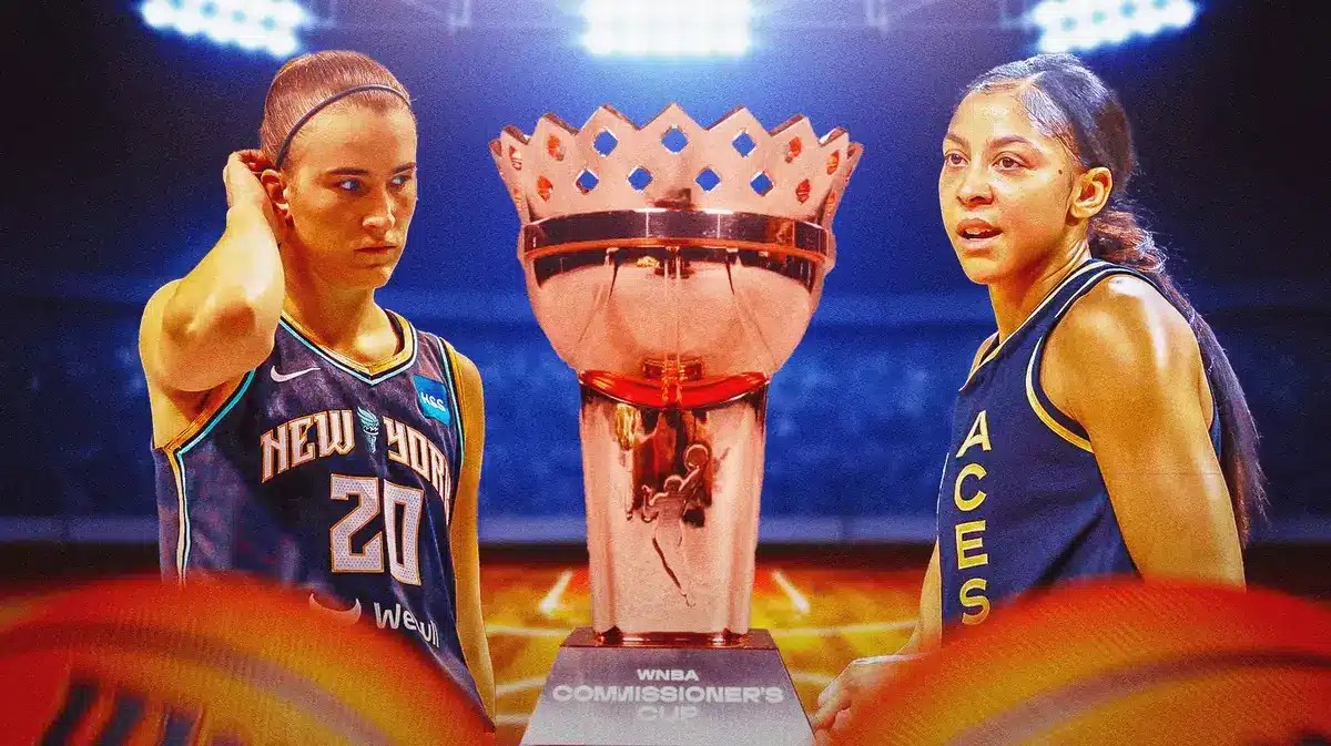 The WNBA Commissioner’s Cup trophy in the center, and with players from the New York Liberty on one side and the Las Vegas Aces on the other